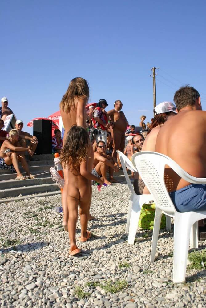 Naturist Standing Sideline - Loyal Followers of the Movement