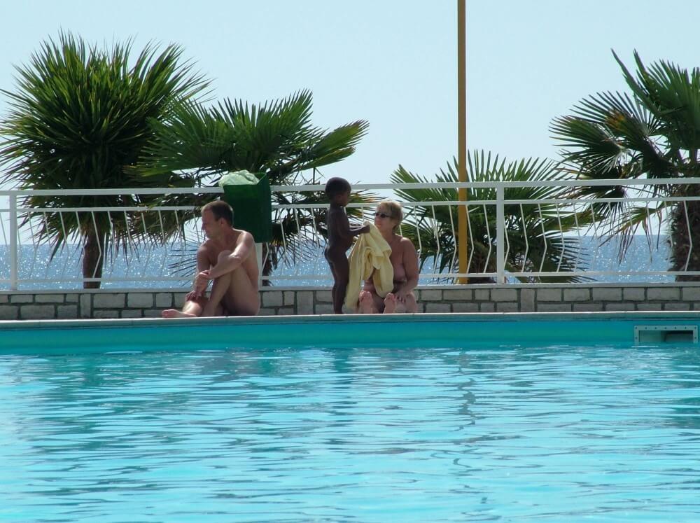 Photo of naturists in an outdoor pool - Overcoming shame and awkwardness when taking off clothes